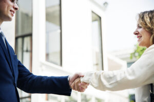 Two people shaking hands after reaching an agreement