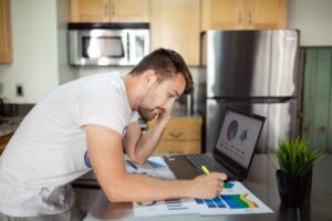 Person reviewing a credit report on a laptop at home