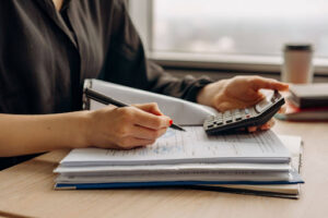 Person reviewing bankruptcy paperwork with a calculator nearby