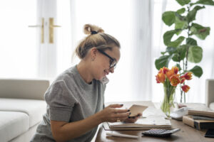 Person reviewing a savings account statement and calendar