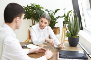 Person having a calm consultation conversation with an advisor